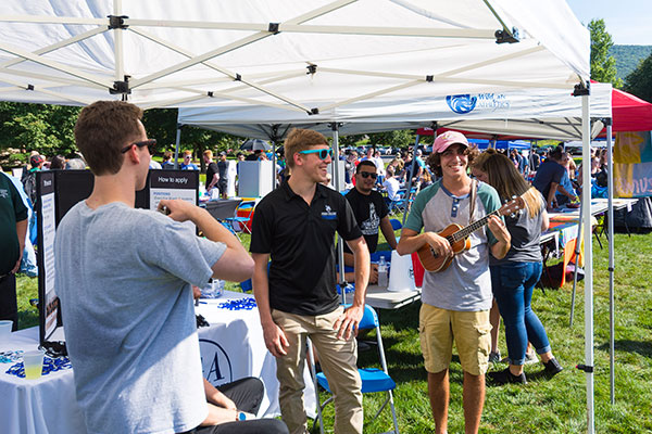 Welcoming visitors to the Student Government Association tent are (from left) Michael E. Highland II, a newly appointed senator from the School of Industrial, Computing & Engineering Technologies; Everett B. Appleby, president; and ­– with what has become his trademark ukelele ­– Patrick C. Ferguson, vice president of finance.
