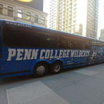 A Penn College-branded Susquehanna Trailways bus drops its passengers at 50th Street and Eighth Avenue in New York City on Saturday.