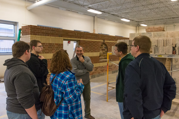 Instructor Glenn R. Luse entertains visitors to the Construction Masonry Building on the northwest corner of campus.