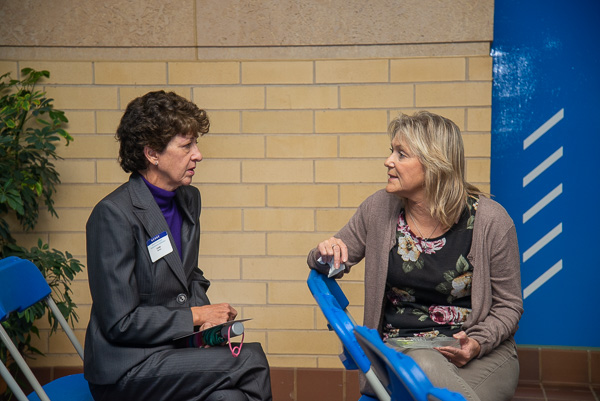 Alumni speaker Tedesco (right) converses with Linda M. Barnes, associate professor of occupational therapy assistant.