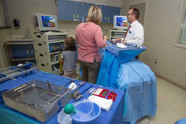 Scott A. Geist, director of surgical technology, shows visitors a laparoscopic simulator. 