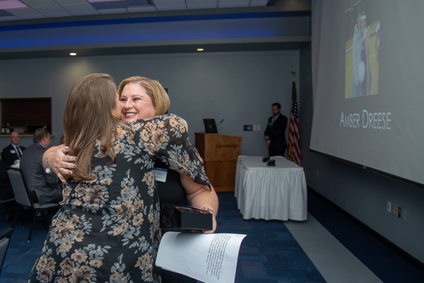 Following her remarks, Dreese receives a congratulatory hug from one of her fans. 