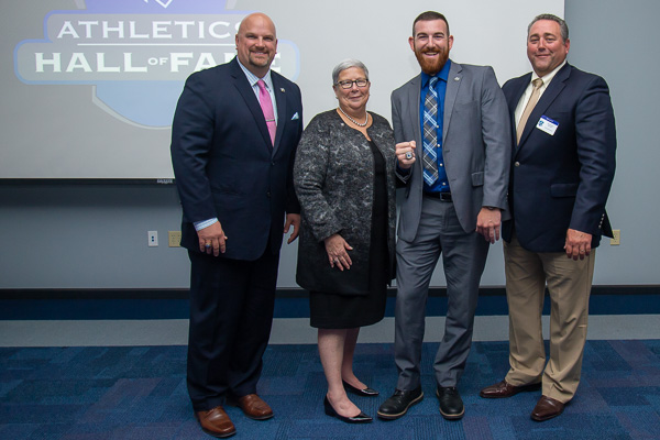 Gingrich savors celebration with his former baseball coach, Chris Howard (right), Vandevere and Gilmour. 