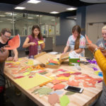 Students in Service Learning in Sociology cut out autumnal decorations for their special event.