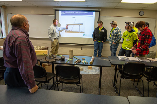 Two civil engineering technology alumni (at left), who now work for Pennsylvania Department of Transportation, discuss their career field and the Central Susquehanna Valley Transportation Project. At left are: T.J. Cunningham, ’90, assistant district engineer, and Lloyd E. Ayres (at screen), ’01, district bridge engineer. 