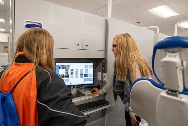 Dental hygiene student Megan P. Fitzsimmons, of Portville, N.Y., discusses X-rays with a potential student in the dental hygiene lab. 
