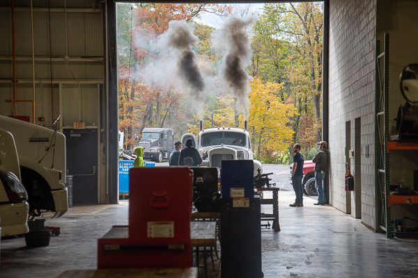 Smoke billows from the 1959 Mack “drag truck” in the diesel lab. 