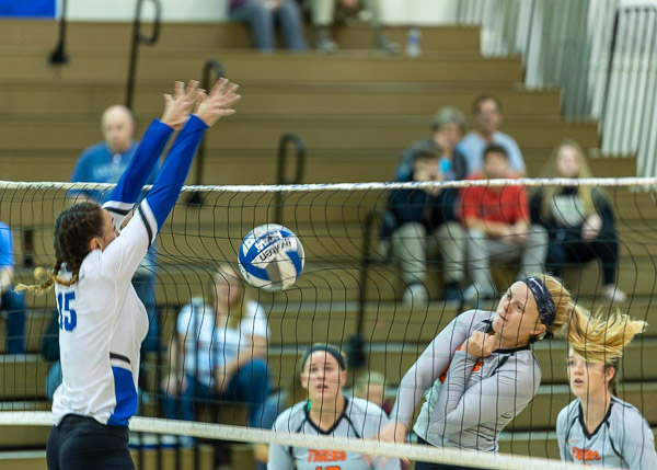 Dramatic play at the net during Saturday's volleyball match against SUNY Cobleskill
