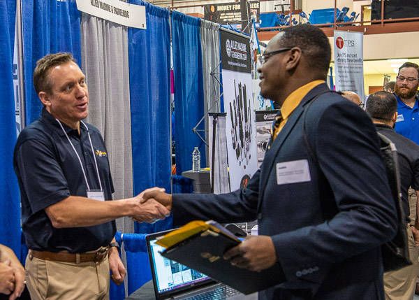 An engaging and enterprising job-seeker touches base with Chris Warnecke (left), of HVAC Concepts.