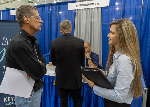 Grant Henry and Jordan M. Scott, of Cogan Station, assess each other's potential at the Keystone Custom Homes booth. Scott is a residential construction technology and management: building construction technology concentration student.