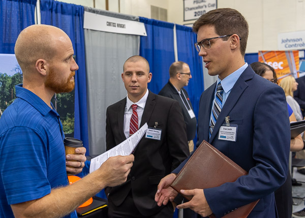 Brandon T. Culbertson (left), a 2016 graduate in civil engineering technology, accepts a resume from construction management student Evan J. Smith, of State College.  Culbertson is a project engineer for HRI Inc.