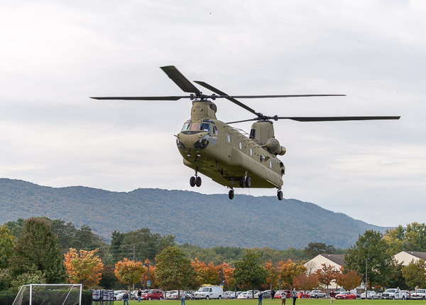 Against a fall-colored backdrop, the Chinook lands outside the library.