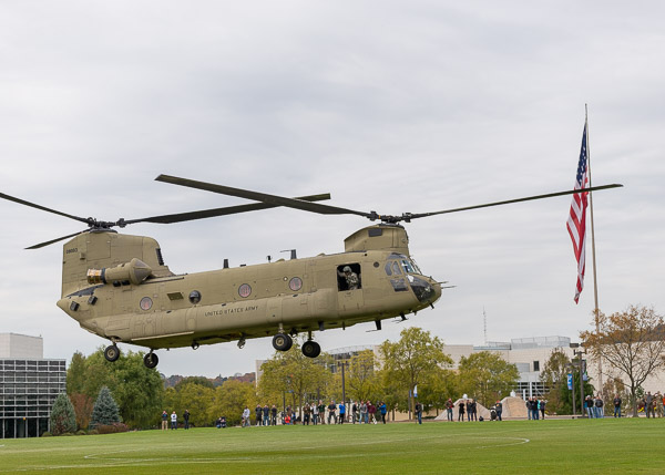 With the Stars and Stripes flying high next-door, the Chinook takes off.