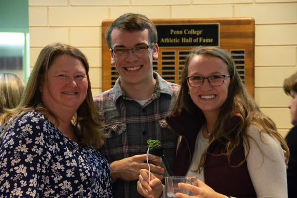 Displaying potted succulents crafted at the Wildcat Postgame Tailgate are Shelley L. Moore, director of career services, and daughter, Gabrielle E., a physician assistant studies major; and Tanner A. Huff, an engineering design technology student.