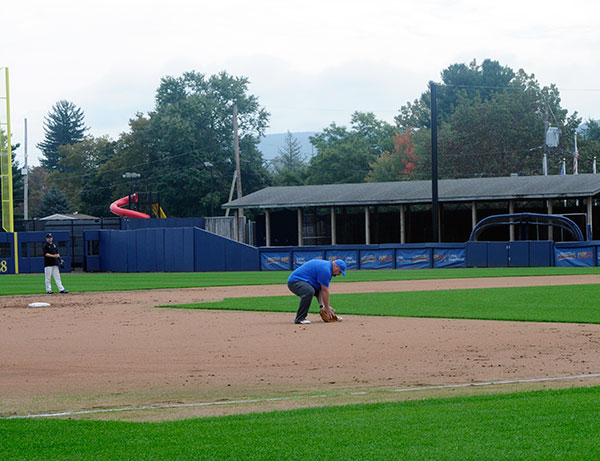 Honoring his losing end of a college football wager, Vandevere takes infield practice with the team.