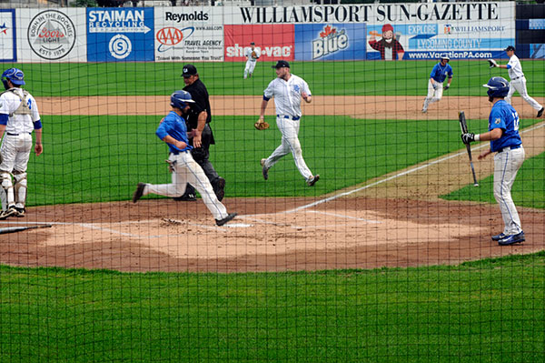 The Blue Team scores, one of five runs in its half of the first inning.