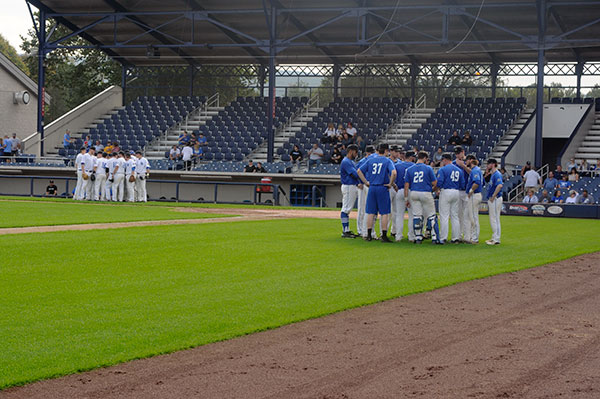The Blue and White teams talk pregame strategy following introductions.