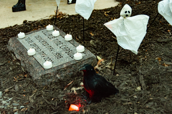 Seasonal ambiance marks the burial site of a time capsule that dates to 1997-98, the first full year that students lived in The Village. The capsule, which contains memorabilia – photos, <br />
<br />
newspaper clippings, a list of then-popular music and fads, etc. – will be opened in May 2023. It was designed and built by former construction instructor James A. Potter II and dedicated <br />
<br />
in memory of Joseph A. DeFeo, Village Council president, who died in April 1998.