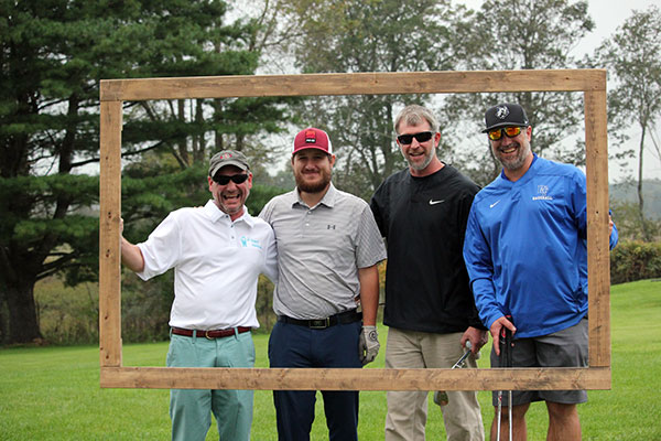 Building construction technology instructors Barney A. Kahn IV (left) and Levon A. Whitmyer (right) fill the frame – and their foursome – with Andrew Levering and Josh Williamson.