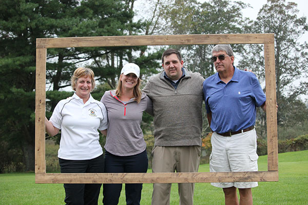 Kathy Poust (left) presents her team of radiography alumna Beth Shaner Kelleher; plastics alumnus Zach Poust and Williamsport Area Community College graduate Lynn Poust.