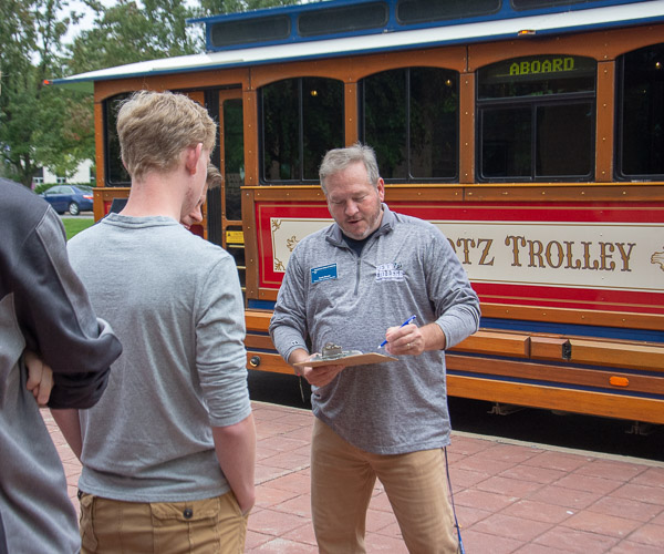 Todd Moore, student affairs marketing specialist, registers families for trolley tours of historic Williamsport.