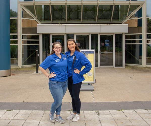 Connections program student assistant Kacie C. Snyder (left), of Bangor, and presidential student ambassador King welcome visitors to open labs in the Breuder Advanced Technology & Health Sciences Center.