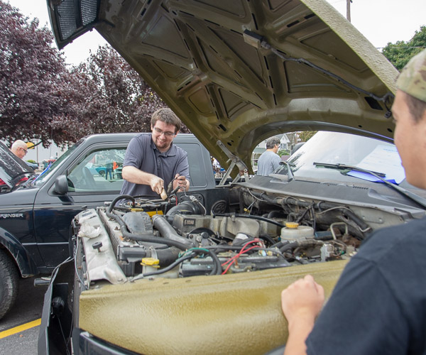 Phi Mu Delta member Robert P. Borden, a welding and fabrication engineering technology student from Glastonbury, Conn., wire brushes his truck’s battery terminals during the fraternity's car show.