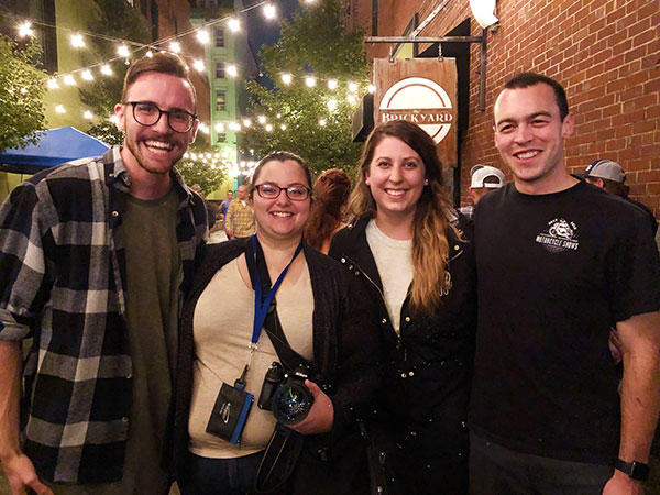 Student photographer Rachel A. Eirmann (second from left) joins a reunion of counterparts who also shared their considerable talents in the job. From left are Caleb G. Schirmer, Haldeman and Marc T. Kaylor. 