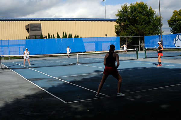 ... as midday sun and shadow mix for women's adjacent play.