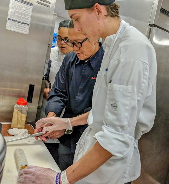 Morimoto provides hands-on instruction to Penn College student Jacob C. Clarke, of Wilmington, Del.