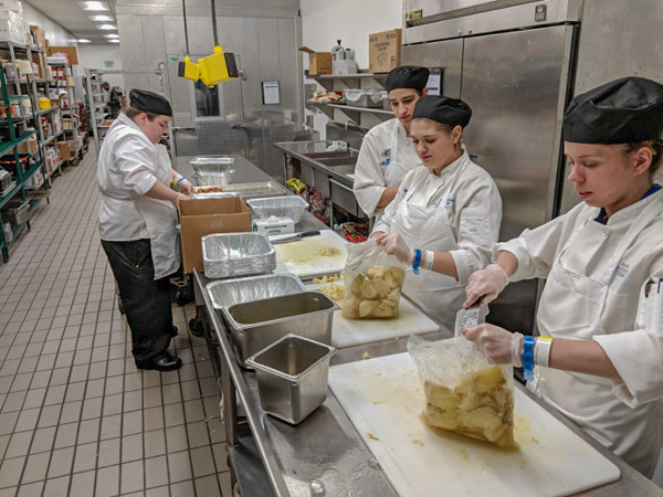 From left, students Dunn; Janelle R. Becker, of Fort Loudon, culinary arts technology; Jacqueline R. Dull, of Mohnton, baking and pastry arts; and Mefferd prepare ingredients.