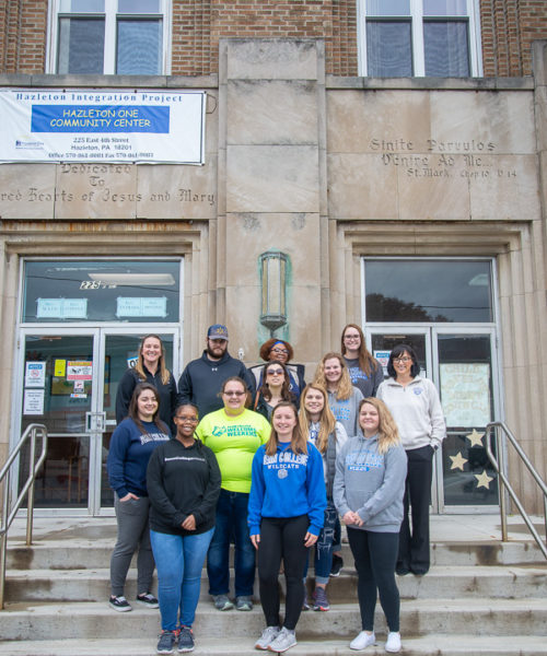 Human services students and their chaperones gather outside the Hazleton One Community Center.