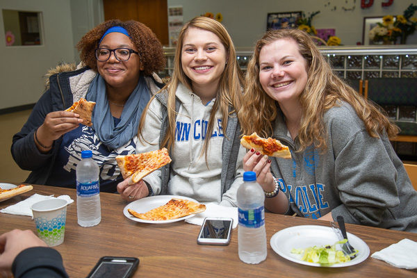 Students (from left) enjoy a pizza party in the center’s cafeteria: Taquicha Ottley, of East Stroudsburg; Skylar L. Bartholomew, of Kempton; and Bryssa A. Dunkleberger, of Williamsport.