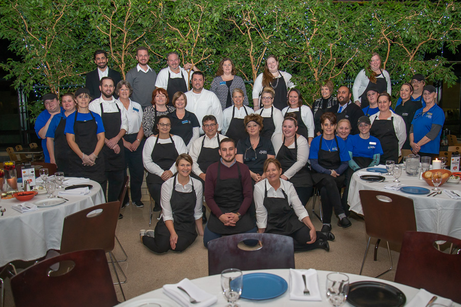 A pre-dinner group photo of the shiny, happy cooks and waiters