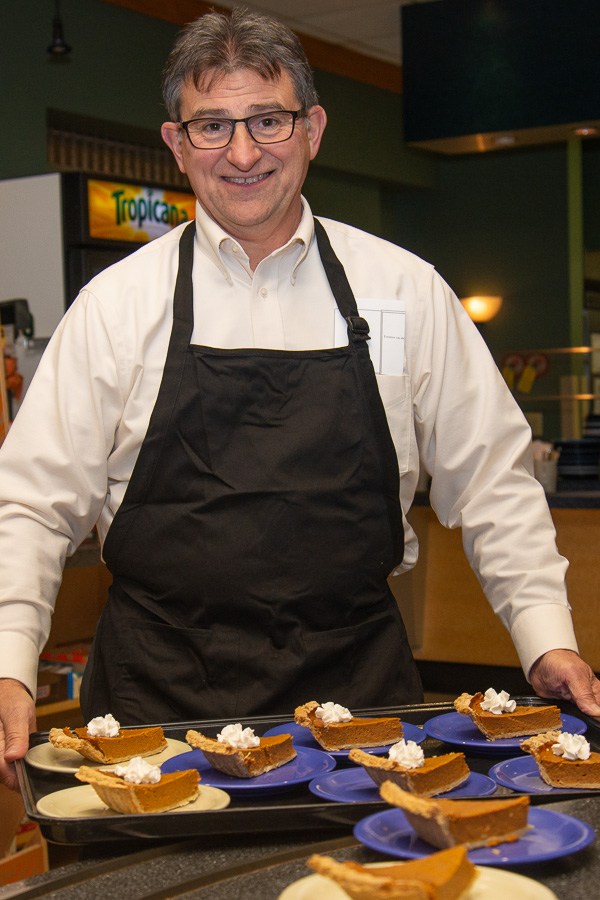Rounding up arresting desserts, Penn College Police Chief Chris E. Miller reports for duty at the fifth annual Thanksgiving dinner for students.
