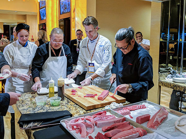 Pennsylvania College of Technology was part of the culinary team at the 2018 Breeders’ Cup Championships at Churchill Downs in Louisville, Kentucky. From left, baking and pastry arts student Amanda M. Brandt, of Etters, York County; Chef Takao Iinuma, of Genji Sushi; and Penn College’s Chef Charles R. Niedermyer, instructor of baking and pastry arts/culinary arts, work alongside Iron Chef Masaharu Morimoto during a demonstration in “The Mansion” at Churchill Downs.