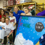 Aided by a youthful band of helping hands, nursing instructor Sherry L. Hyland (in red); clinical director Tanae A. Traister (kneeling) and Jessica L. Bower, simulation laboratory coordinator, show off their work.