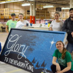 Cru unveils its finished entry. Kneeling (from left) are Kimberly R. Masullo, of Effort, and Amber L. Way, of Port Matilda. Standing (from left) are Zachary L. Alexander, of Liberty; Natali J. Fargus, of Lock Haven; Kyrsten-Lee Baker, of Milton; and Nathaniel H. Lyon, of Fredericksburg.