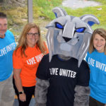 The Wildcat and members of the Penn College United Way Campaign committee don T-shirts to share their "Live United" message with the campus community. From left are electrical faculty member Art L. Counterman, president of the Penn College Education Association; Heather L. Allison, workforce development consultant; and Katie L. Mackey, director of campus and community engagement.