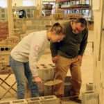 Luse shares pointers with Julia R. Straub, a Penn State student well-acquainted with construction through her family's experience in the field. "I've been playing with plumbing since I was 8," she said, "but they never let me do the dirty work." Until now, that is!