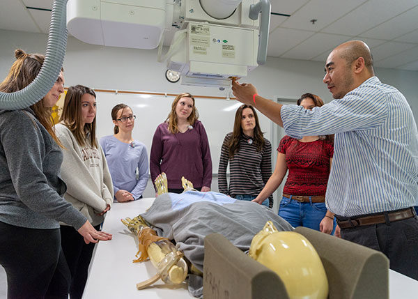 Qiang Cao (right), instructor of radiography at Pennsylvania College of Technology, leads students in capturing images in the college’s digitally equipped radiography lab. The college’s radiography program is celebrating National Radiologic Technology Week.