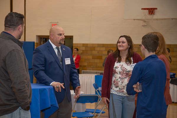 Director of Athletics John D. Vandevere and Christine A. Limbert, an officer with the Student Athlete Advisory Committee and a volleyball player, converse with guests. Limbert is an architectural technology student from Curwensville. 