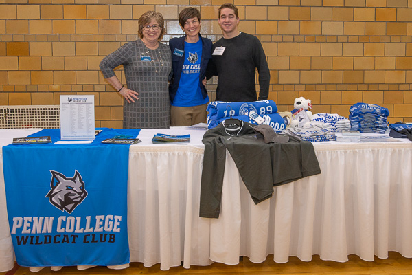 Smiles and gear a-plenty! From left: Angela E. Myers, director of annual giving; Becky J. Shaner, senior manager of donor relations and special events; and Zachary J. Kravitz, student development assistant and construction management student, offer options for club membership – including a student level. 