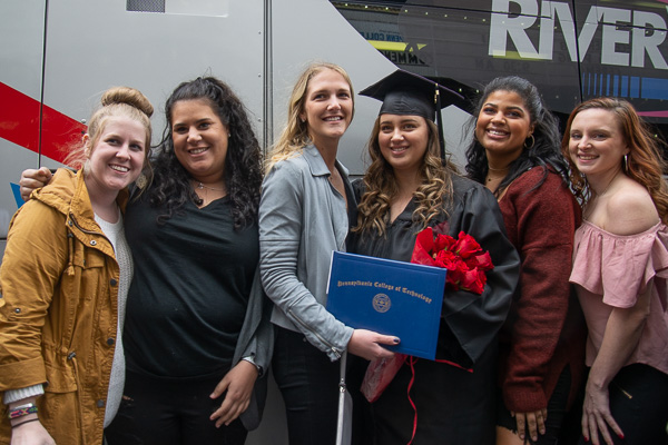 Kaitlyn M. Nasdeo, of Williamsport, celebrates postceremony with friends. She earned a degree in business administration: sport and event management concentration.