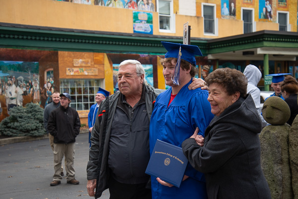 Luke B. Walter savors celebration with his grandparents. Walter, of Millmont, graduated in welding technology.