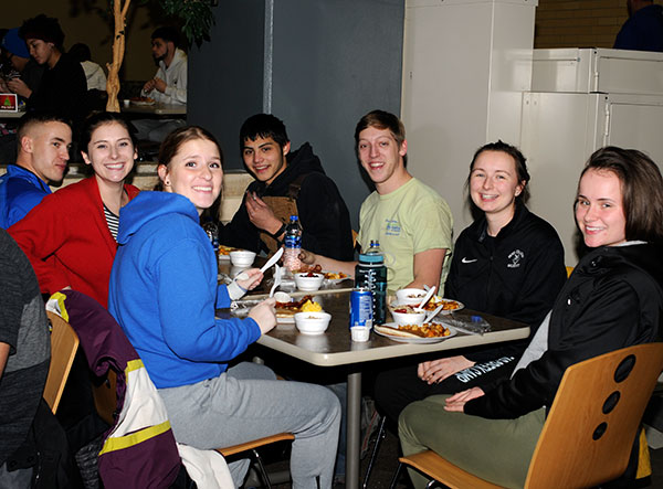A table of active student leaders takes a much-deserved break, basking in food and friendship.