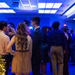 Illuminated in blue and highlighted by the tree's seasonal glow