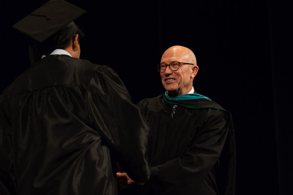 Johnson joined the president in an enthusiastic tribute to each graduate's achievement.
