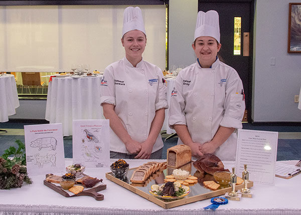As part of Pennsylvania College of Technology’s annual Food Show, culinary arts technology students Summer L. Showers, left, of Aspers, and Chelsea L. Gray, of Marysville, receive the Chef Eugene Mattucci Best of Show award for their “Game Meats From the Hunt” platter and charcuterie board.