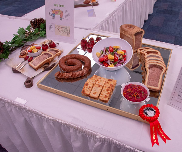 … that includes a hearty fruit and vegetable salad, haymarket pate en croute with cranberry orange chutney, horseradish- and beet-cured salmon florets, and spicy smoked chorizo sausage.